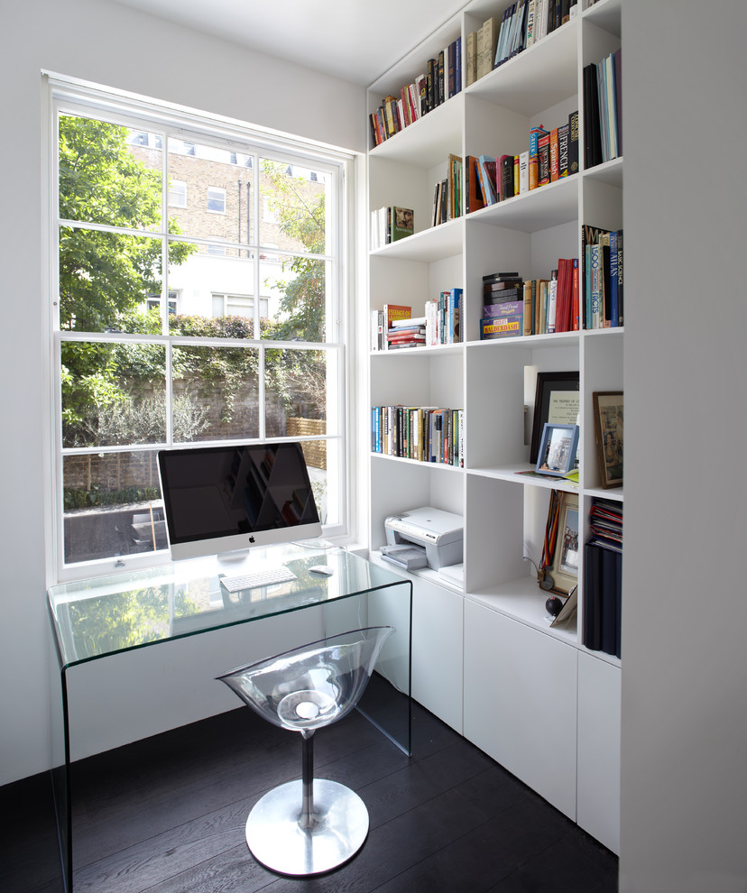 Photo of a small contemporary home office in London with white walls, dark hardwood floors, no fireplace and a freestanding desk.