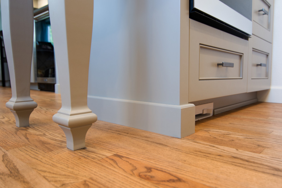 Kitchen - mid-sized transitional l-shaped medium tone wood floor and brown floor kitchen idea with an undermount sink, recessed-panel cabinets, gray cabinets, quartz countertops, white backsplash, ceramic backsplash, stainless steel appliances, a peninsula and white countertops