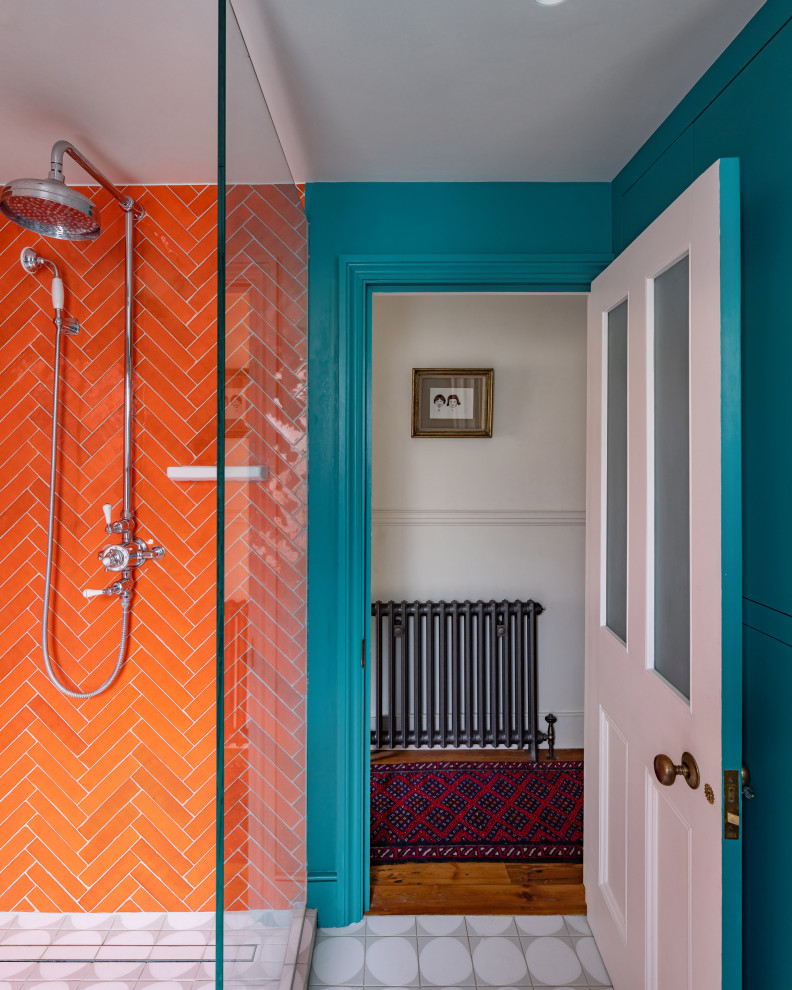 Mid-sized eclectic kids bathroom in London with orange tile, a single vanity and a floating vanity.