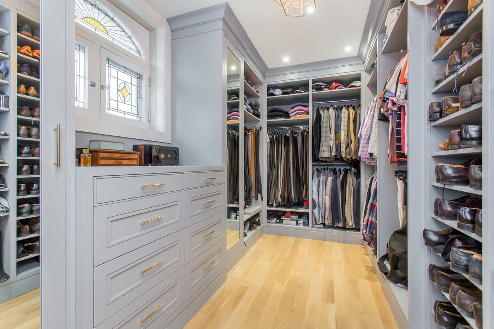 Design ideas for a transitional men's dressing room in Toronto with open cabinets, grey cabinets, medium hardwood floors and beige floor.
