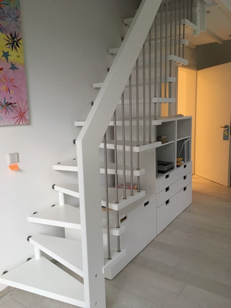 Example of a large wooden straight staircase design in Other with wooden risers
