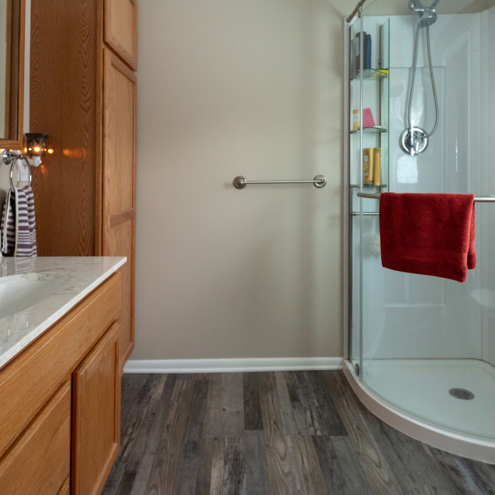 Inspiration for a small transitional l-shaped vinyl floor and brown floor enclosed kitchen remodel with an undermount sink, shaker cabinets, green cabinets, quartz countertops, stainless steel appliances, a peninsula and gray countertops