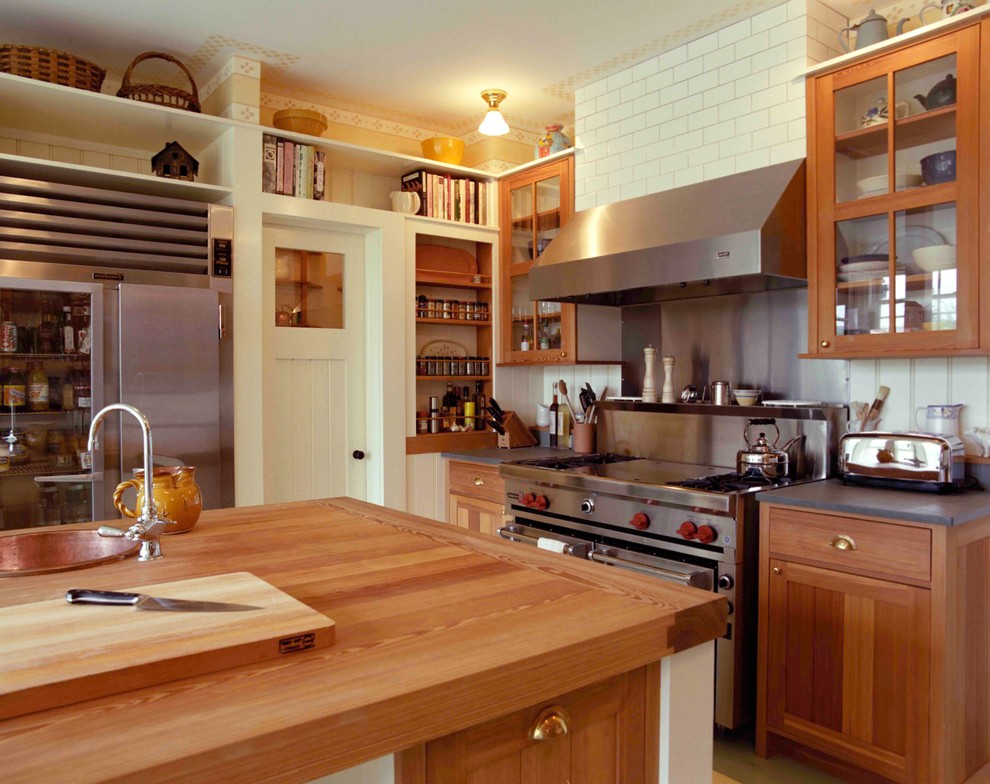 Photo of a mid-sized transitional u-shaped separate kitchen in Bridgeport with a farmhouse sink, shaker cabinets, medium wood cabinets, soapstone benchtops, white splashback, cement tile splashback, stainless steel appliances, painted wood floors and with island.