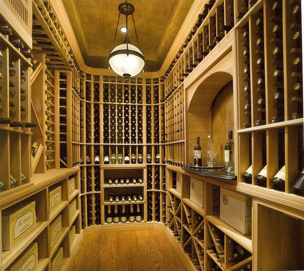 Inspiration for a mid-sized traditional wine cellar in Philadelphia with medium hardwood floors, storage racks and brown floor.
