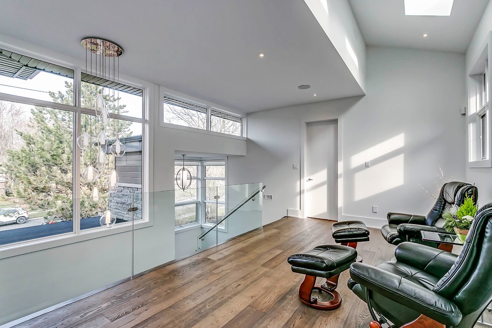 Inspiration for a transitional medium tone wood floor hallway remodel in Toronto with white walls
