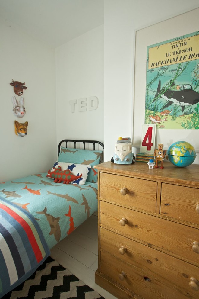 Photo of a traditional kids' room for kids 4-10 years old and boys in Other with white walls and painted wood floors.