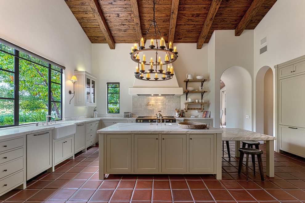 Inspiration for a mediterranean u-shaped kitchen in Other with an undermount sink, shaker cabinets, beige cabinets, white splashback, terra-cotta floors, with island and red floor.