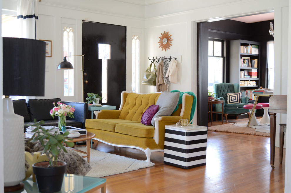 Photo of an eclectic enclosed living room in Dallas with white walls and medium hardwood floors.