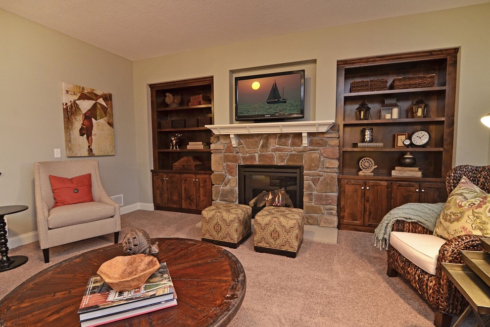 Photo of a traditional living room in Minneapolis with a stone fireplace surround and a built-in media wall.