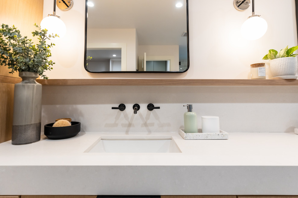 This is an example of a large modern master bathroom in Dallas with flat-panel cabinets, light wood cabinets, engineered quartz benchtops, a double vanity and a floating vanity.