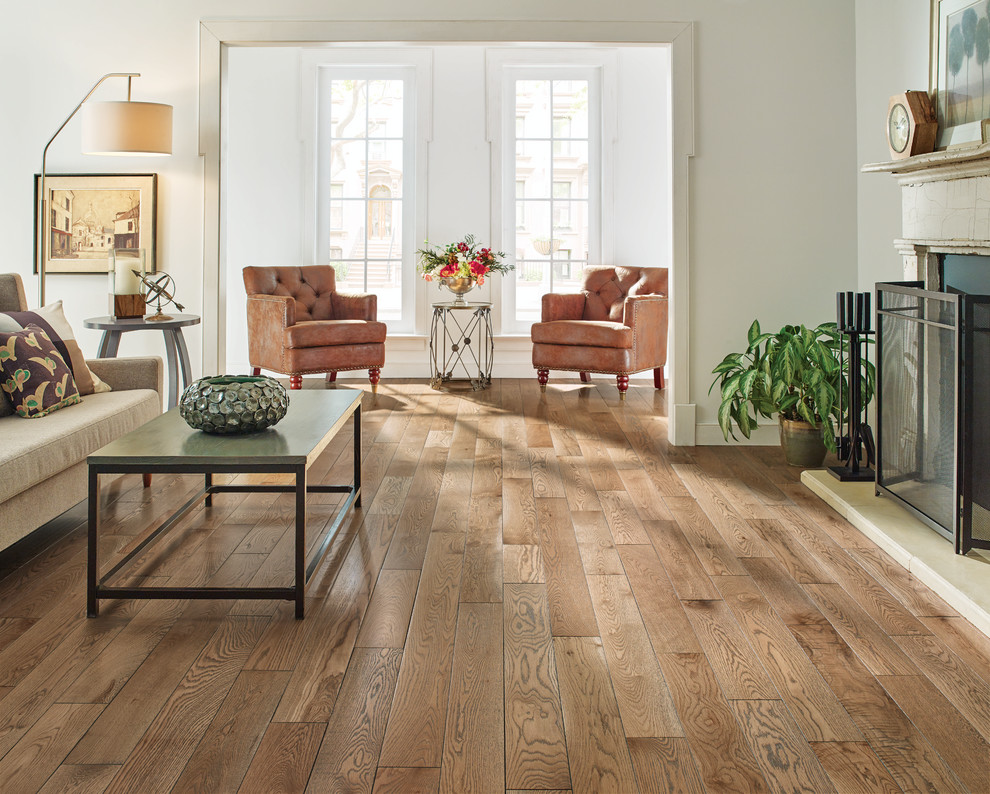 Inspiration for a mid-sized transitional formal and open concept medium tone wood floor and brown floor living room remodel in New York with white walls, a standard fireplace, a wood fireplace surround and no tv
