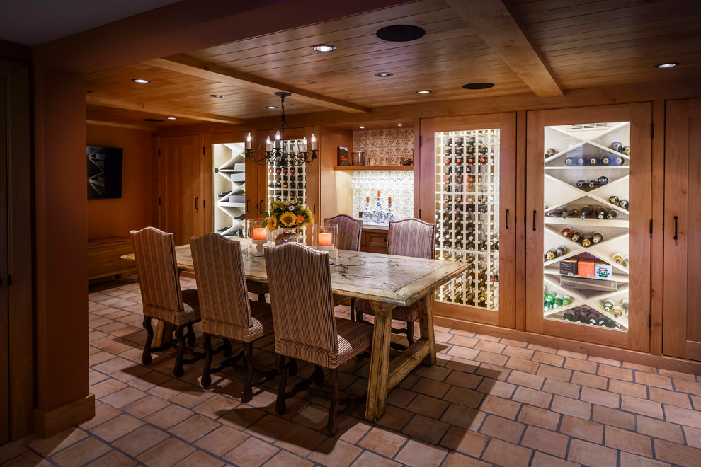 This is an example of a large country wine cellar in San Francisco with storage racks and terra-cotta floors.