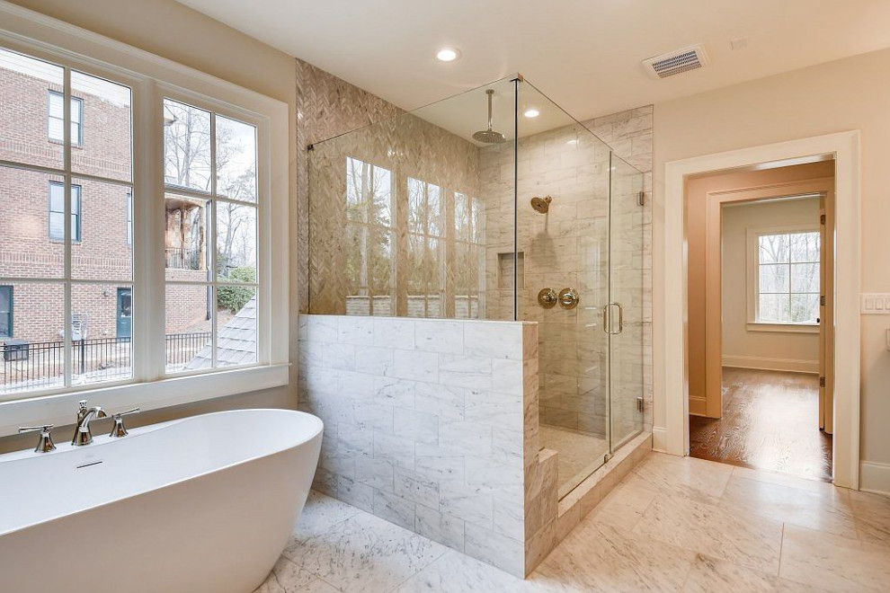 Inspiration for a large transitional master bathroom in Atlanta with shaker cabinets, grey cabinets, a freestanding tub, a corner shower, white tile, marble, grey walls, marble floors, marble benchtops, grey floor, a hinged shower door, white benchtops, a double vanity and a freestanding vanity.