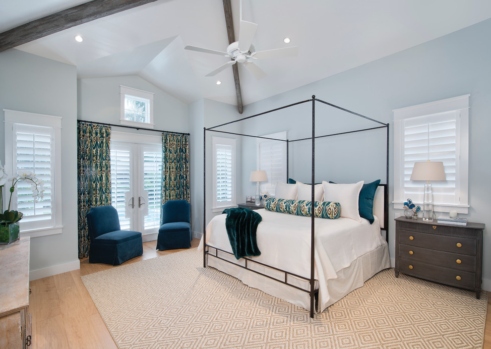 Inspiration for a transitional master bedroom in Miami with blue walls and light hardwood floors.