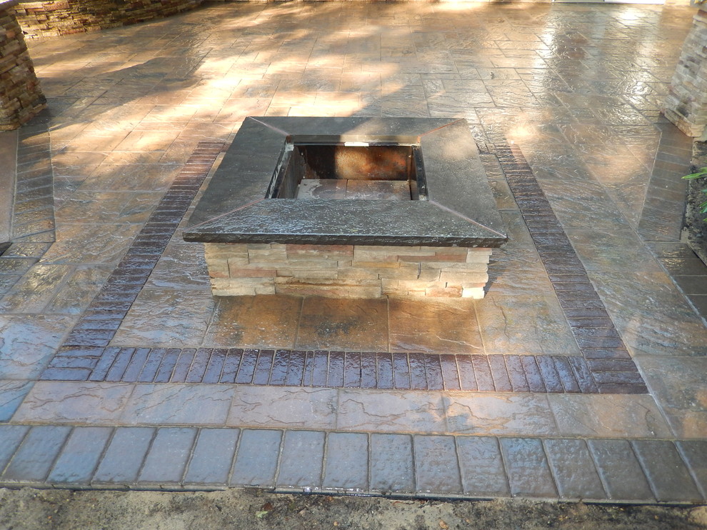 Mid-sized contemporary backyard patio in Newark with a fire feature and concrete pavers.