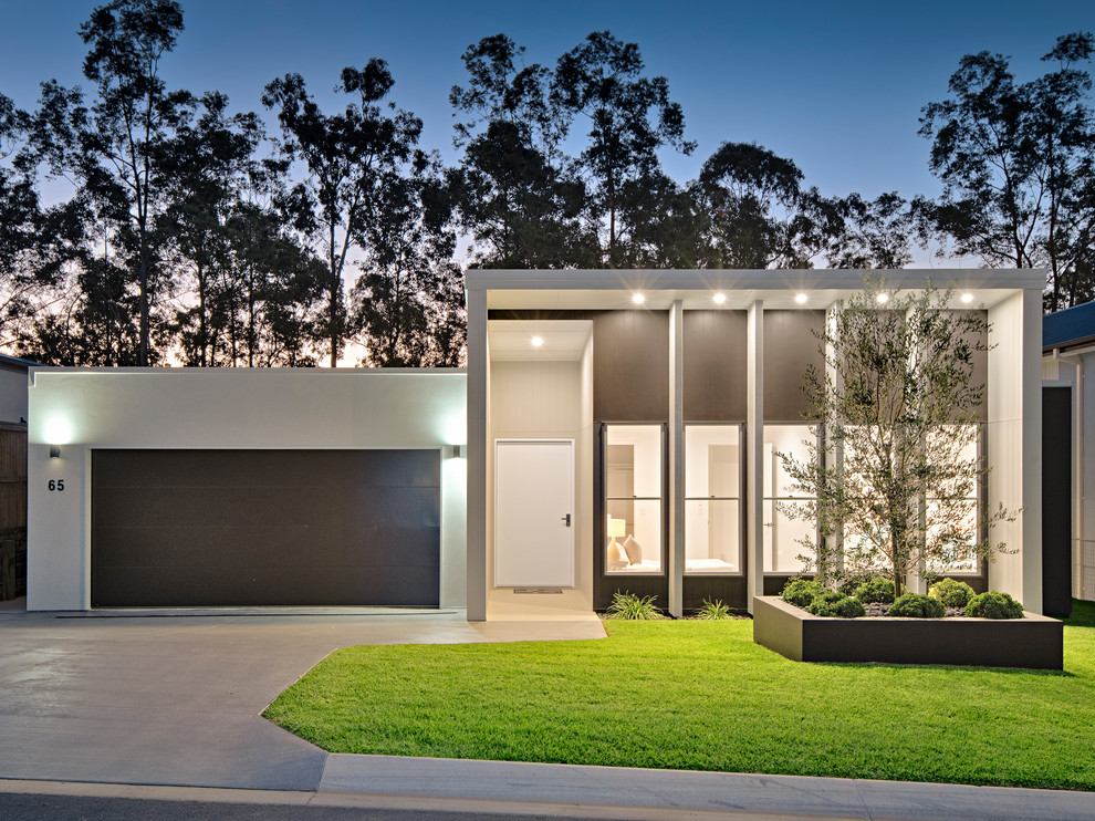 Mid-sized modern one-storey grey house exterior in Brisbane with mixed siding, a flat roof and a metal roof.
