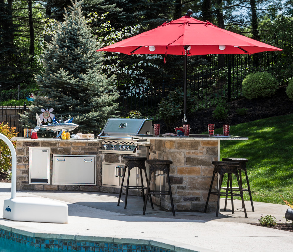 Inspiration for a traditional backyard patio in St Louis with an outdoor kitchen, stamped concrete and no cover.