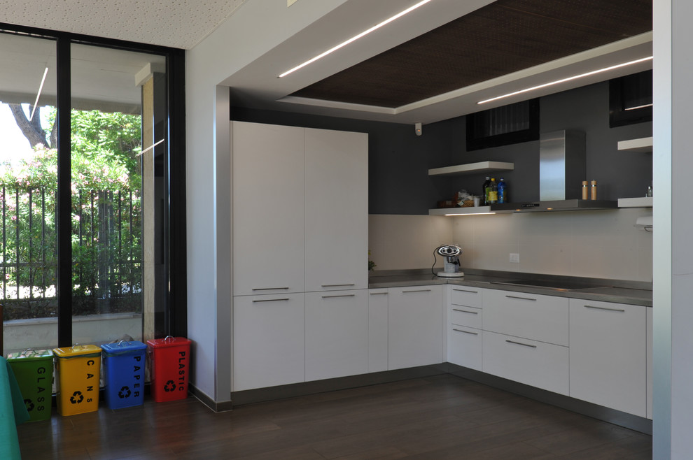Inspiration for an expansive contemporary u-shaped eat-in kitchen in Rome with a double-bowl sink, beaded inset cabinets, white cabinets, stainless steel benchtops, white splashback, porcelain splashback, stainless steel appliances, porcelain floors and grey floor.