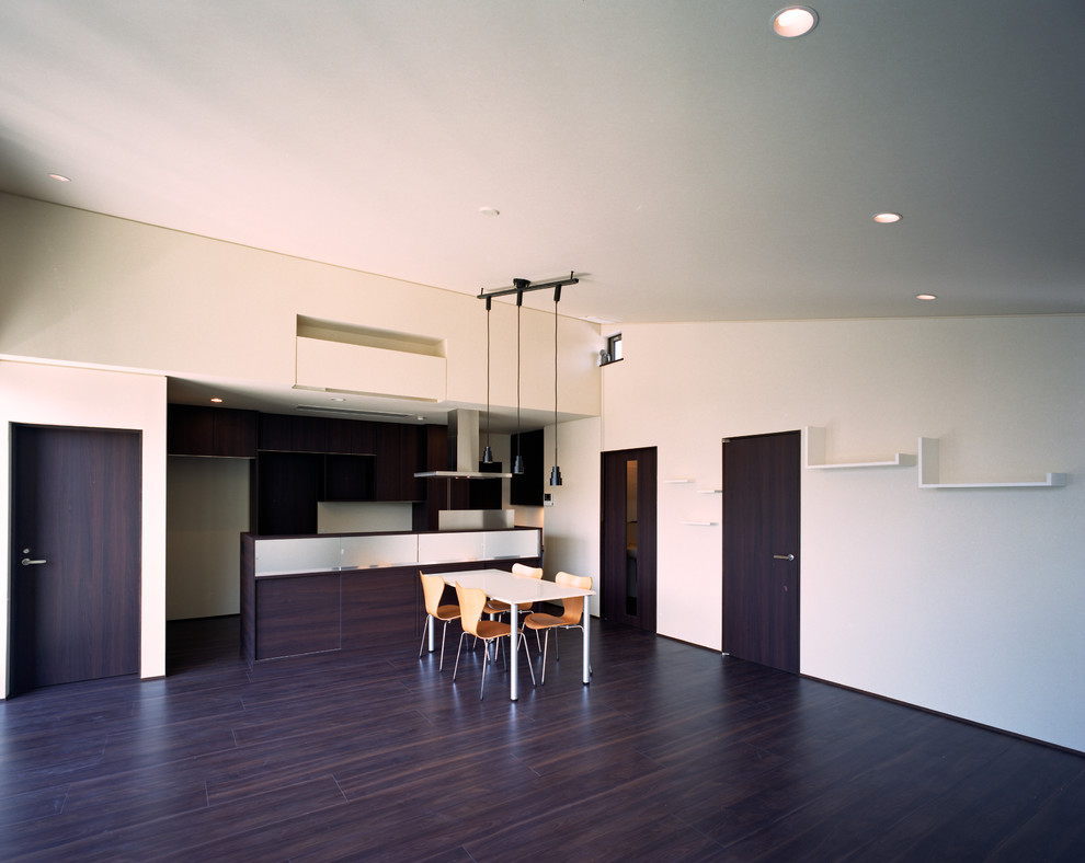 Mid-sized modern open concept living room in Tokyo Suburbs with a music area, dark hardwood floors, no fireplace, a plaster fireplace surround, a freestanding tv, black floor and white walls.