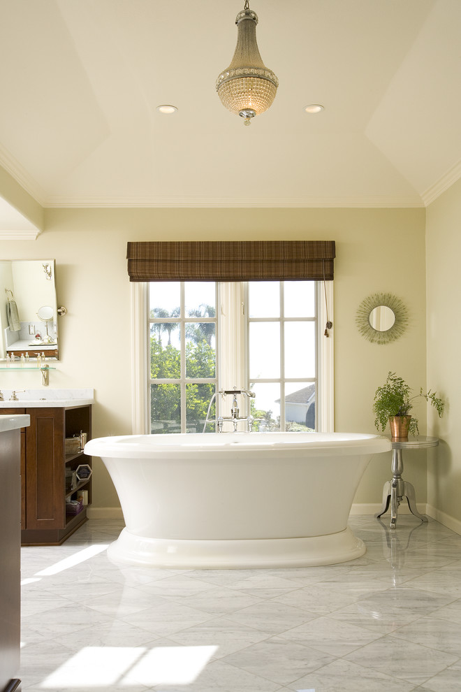 Inspiration for a large traditional master bathroom in Los Angeles with a freestanding tub, marble floors, recessed-panel cabinets, brown cabinets, white tile, subway tile, an undermount sink, marble benchtops, white floor, a hinged shower door, an alcove shower and green walls.