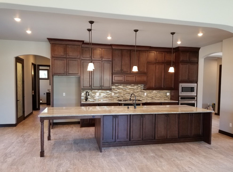 Design ideas for an expansive contemporary galley eat-in kitchen in Cleveland with an undermount sink, flat-panel cabinets, brown cabinets, marble benchtops, brown splashback, mosaic tile splashback, stainless steel appliances, terrazzo floors, with island, brown floor and brown benchtop.