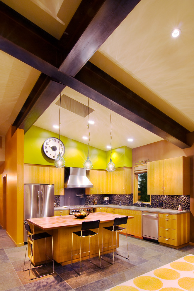 This is an example of a contemporary kitchen in Sacramento with flat-panel cabinets and medium wood cabinets.