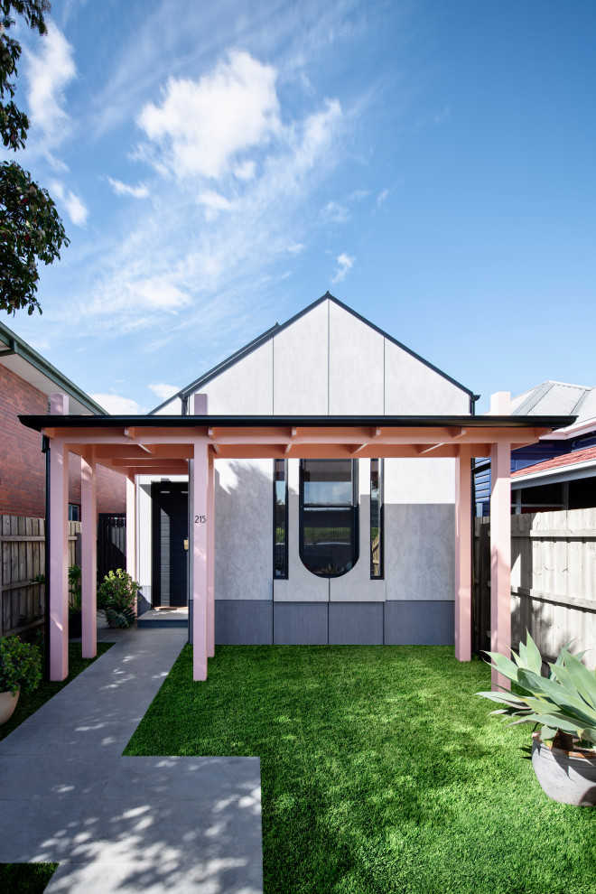 This is an example of a contemporary one-storey white house exterior in Melbourne with a gable roof.