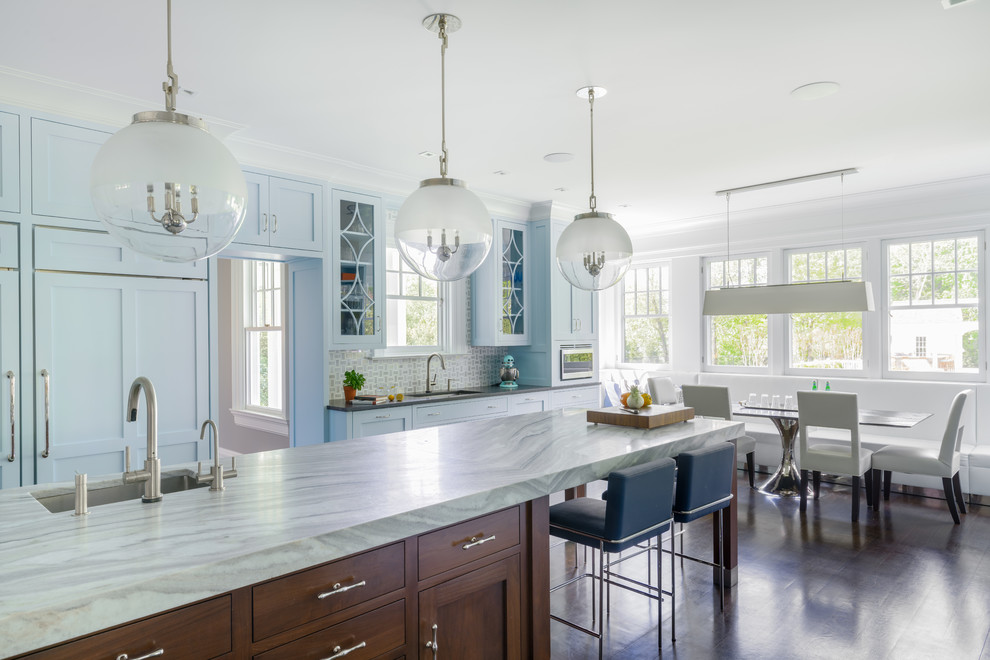 Beach style eat-in kitchen in New York with an undermount sink, shaker cabinets, blue cabinets, grey splashback, dark hardwood floors, with island, brown floor, grey benchtop and marble benchtops.