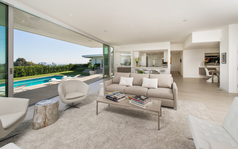 Design ideas for a contemporary open concept living room in Los Angeles with light hardwood floors.