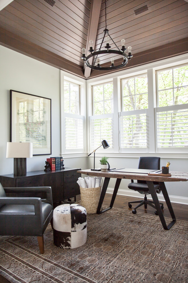 Transitional home office in Chicago with white walls, medium hardwood floors, a freestanding desk and brown floor.