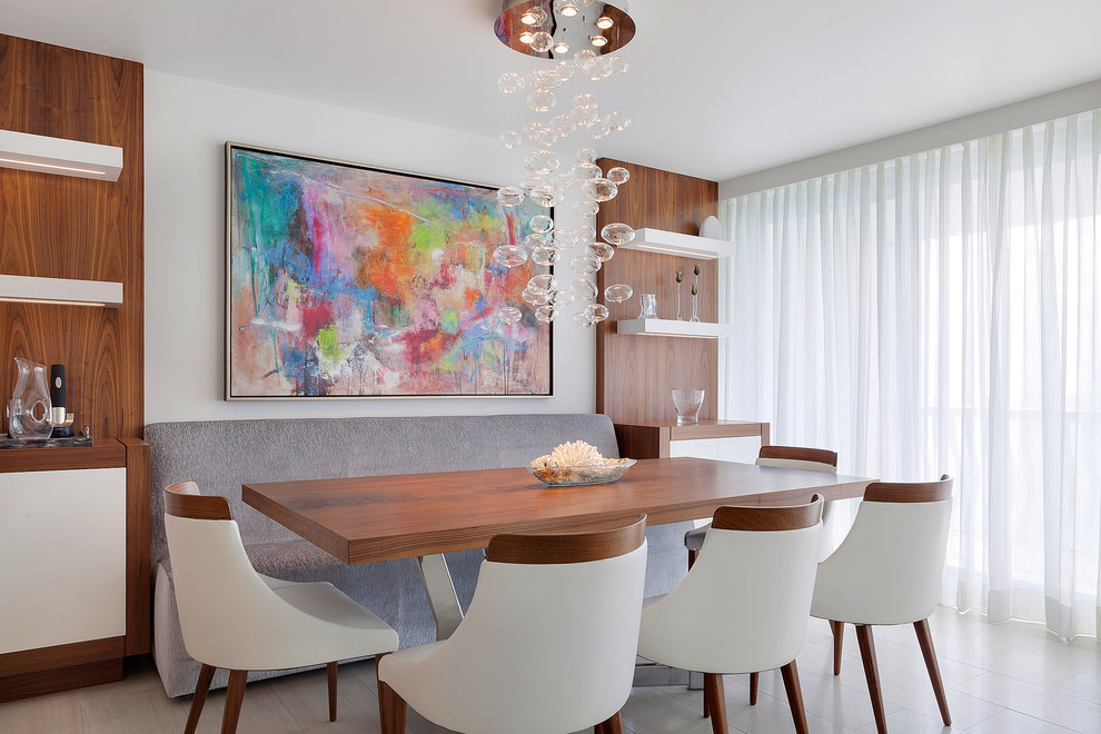 Contemporary dining room in Miami with grey walls.