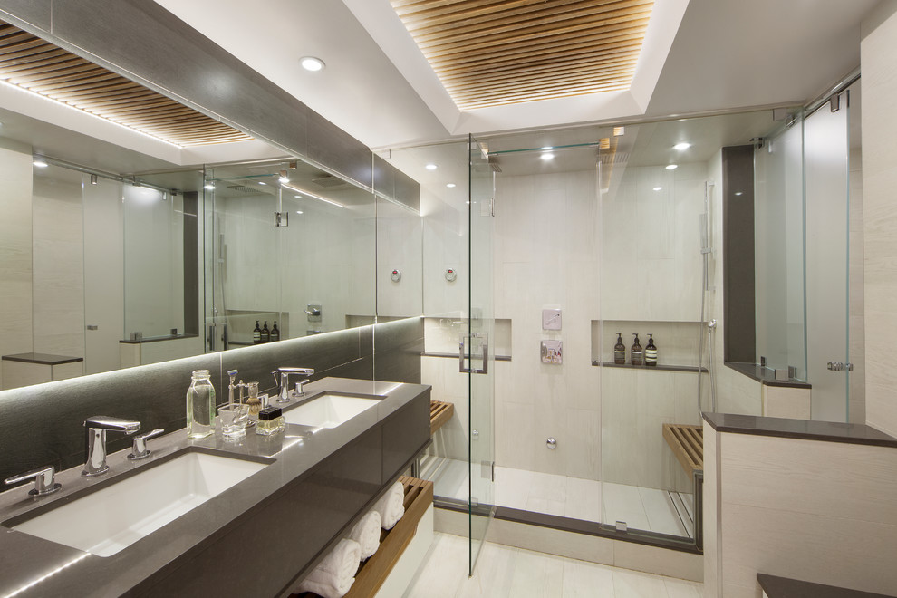 Photo of a mid-sized contemporary master bathroom in New York with an undermount sink, beige walls, a one-piece toilet, multi-coloured tile, porcelain tile and porcelain floors.