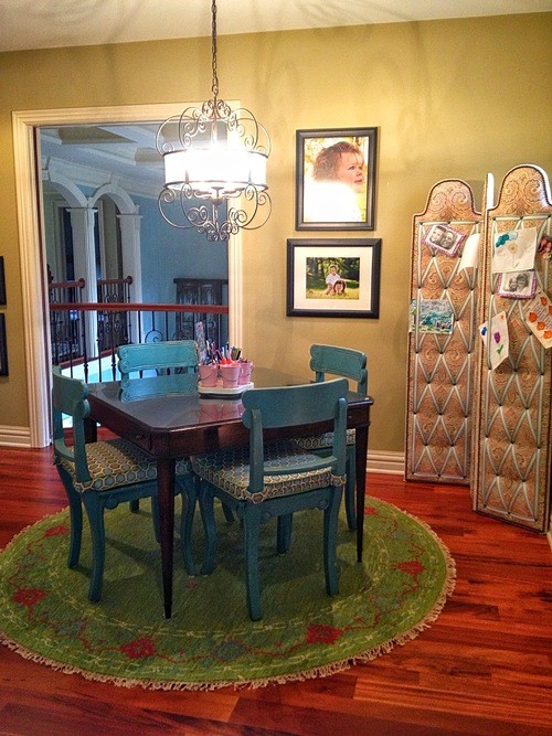 This is an example of a mid-sized traditional dining room in Columbus with green walls and medium hardwood floors.