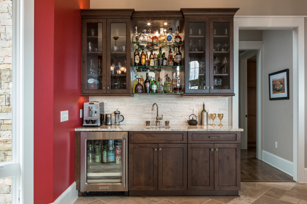 Design ideas for a large transitional single-wall home bar in Raleigh with an undermount sink, shaker cabinets, medium wood cabinets and multi-coloured splashback.