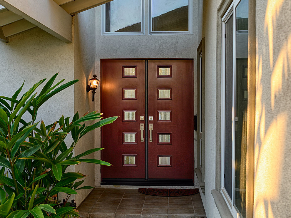 Inspiration for a large contemporary front door in Orange County with grey walls, a double front door and a dark wood front door.