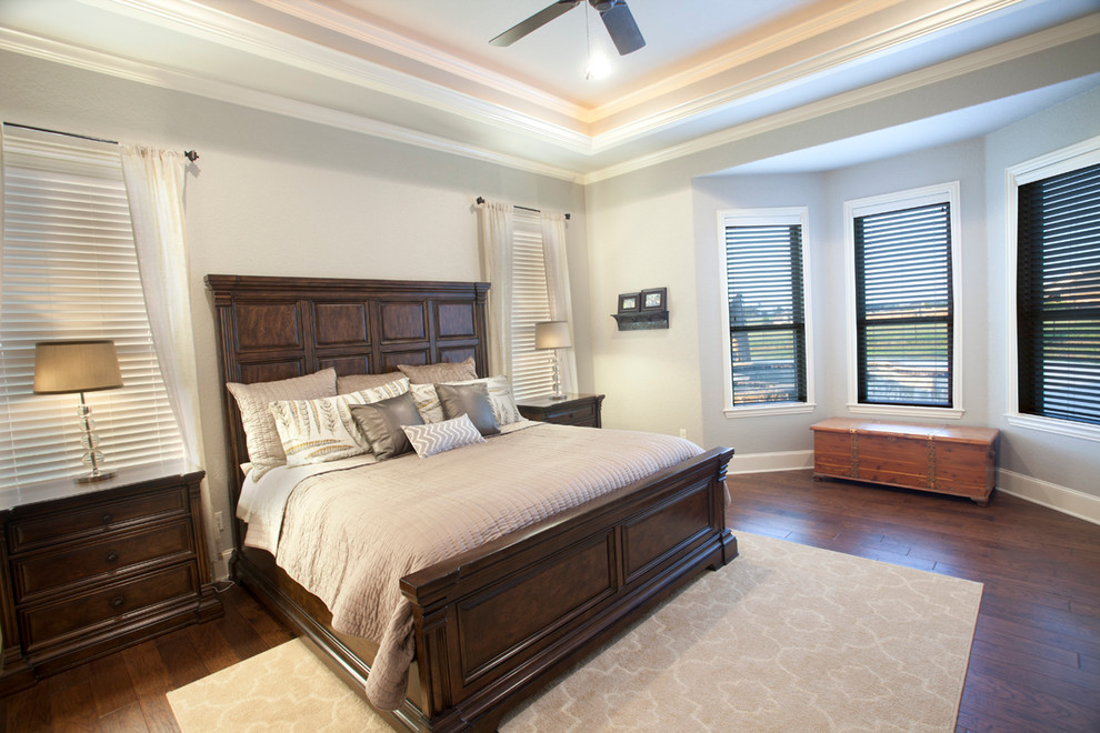Inspiration for a large traditional master bedroom in Dallas with grey walls and dark hardwood floors.