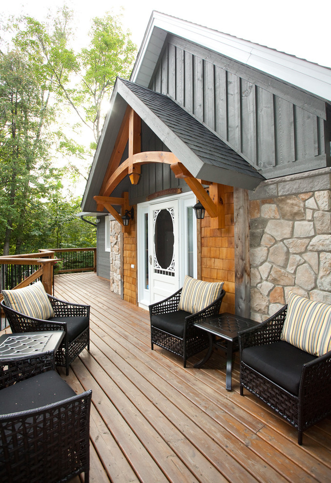 Inspiration for a mid-sized arts and crafts front yard verandah in Ottawa with decking.