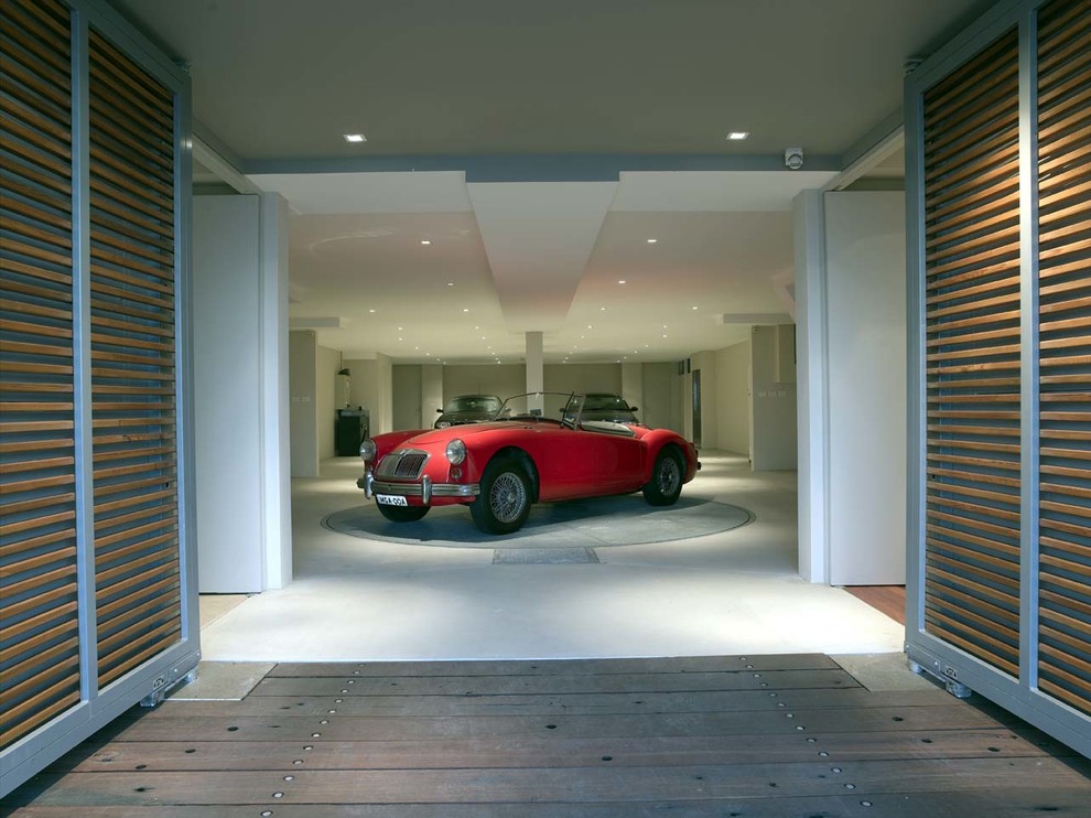 This is an example of an expansive contemporary attached three-car carport in Sydney.