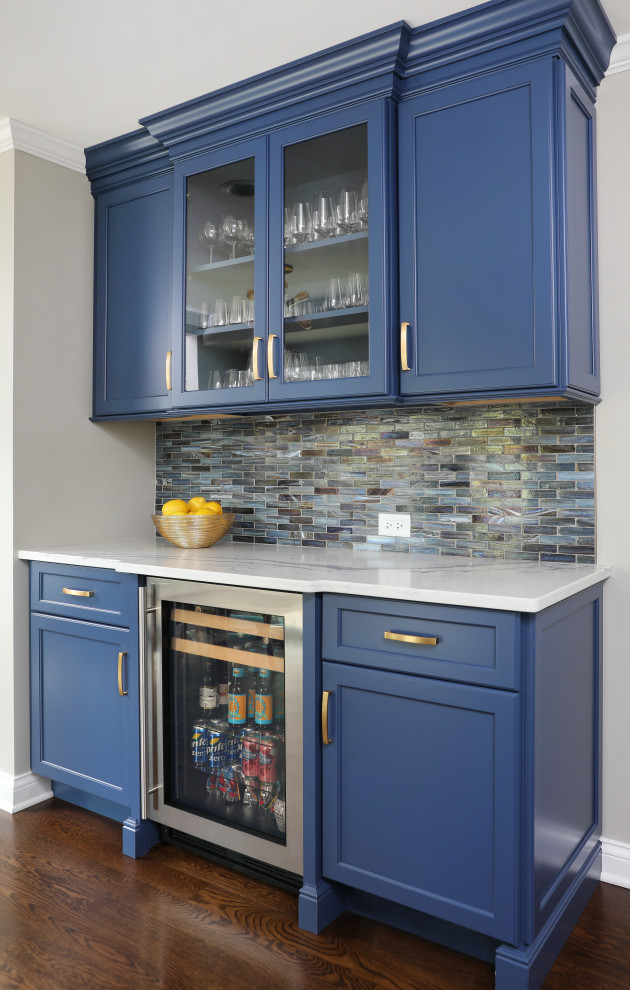 Inspiration for a transitional medium tone wood floor and brown floor eat-in kitchen remodel in Chicago with shaker cabinets, blue cabinets, quartz countertops, blue backsplash, subway tile backsplash and stainless steel appliances