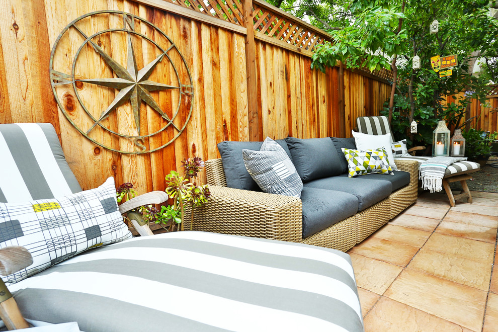 Inspiration for a small contemporary backyard patio in San Francisco with natural stone pavers.