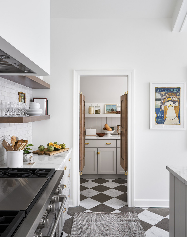 Photo of a large country u-shaped eat-in kitchen in Chicago with a farmhouse sink, shaker cabinets, grey cabinets, white splashback, terra-cotta splashback, stainless steel appliances, marble floors, with island, multi-coloured floor and white benchtop.