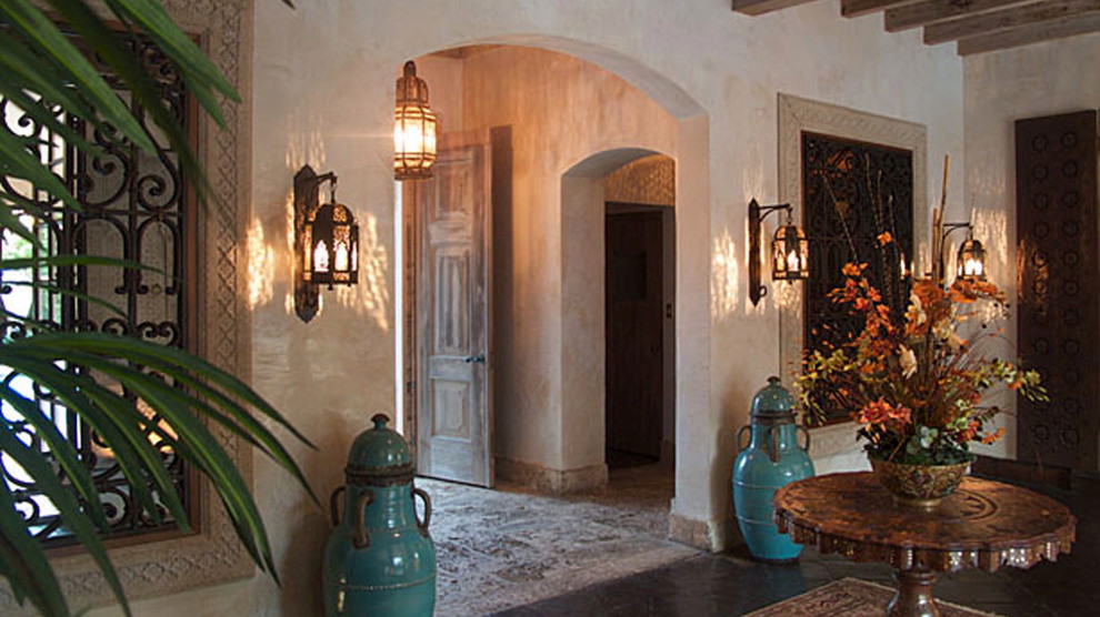 Inspiration for a large mediterranean entry hall in Miami with white walls and ceramic floors.