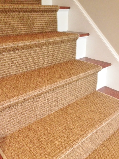 This is an example of a small transitional wood straight staircase in Burlington with painted wood risers.