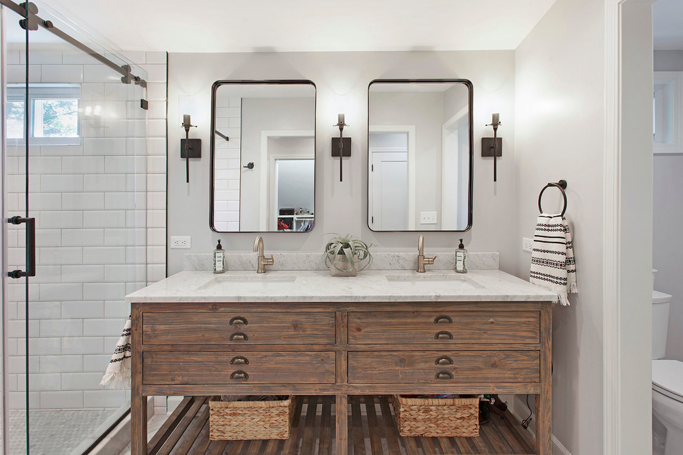 Transitional bathroom in Kansas City with medium wood cabinets, an alcove shower, a two-piece toilet, grey walls, an undermount sink, a sliding shower screen, white benchtops and flat-panel cabinets.