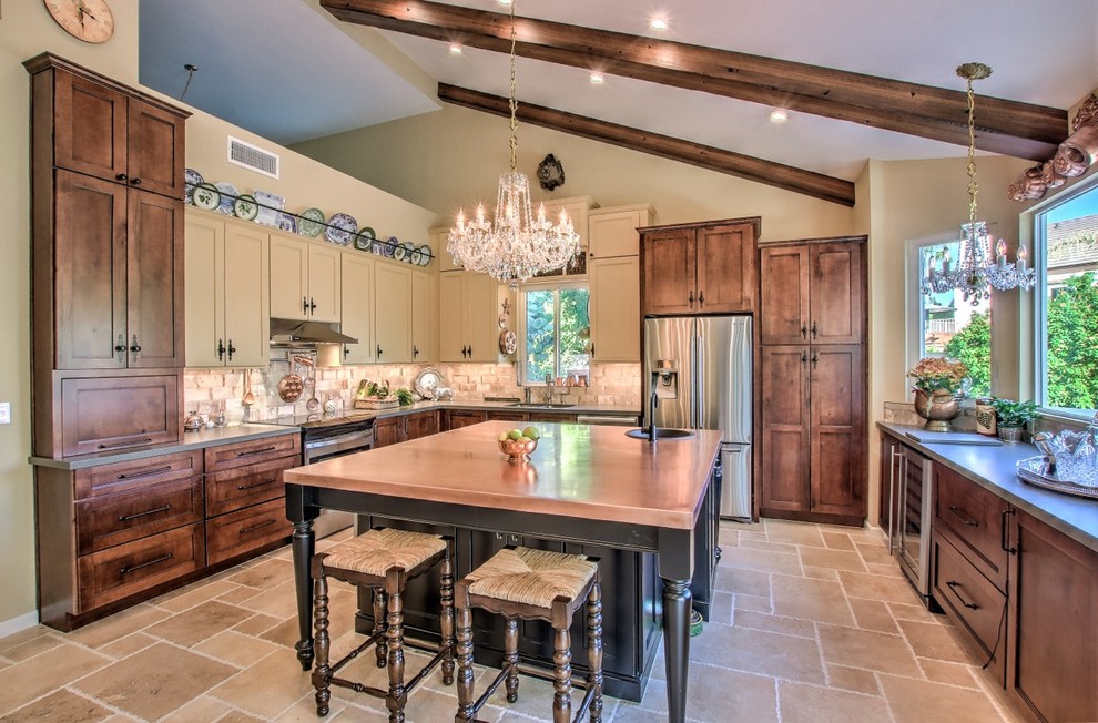 Inspiration for a mid-sized eclectic porcelain tile and beige floor eat-in kitchen remodel in Phoenix with a single-bowl sink, shaker cabinets, black cabinets, copper countertops, beige backsplash, travertine backsplash, stainless steel appliances and an island