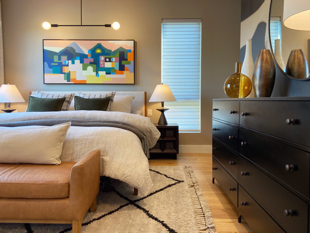 Imagen de dormitorio principal moderno con paredes beige, suelo de madera clara y papel pintado