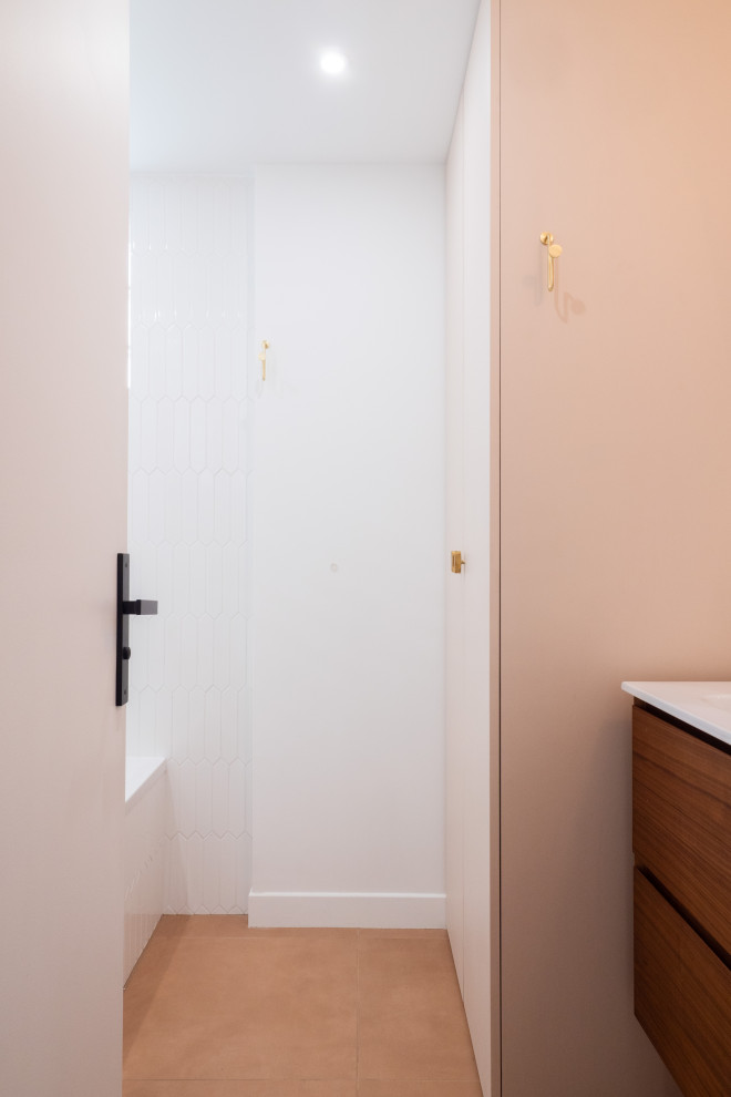 Inspiration för mellanstora moderna vitt en-suite badrum, med luckor med infälld panel, vita skåp, ett undermonterat badkar, en dusch/badkar-kombination, vit kakel, vita väggar, ett väggmonterat handfat och med dusch som är öppen
