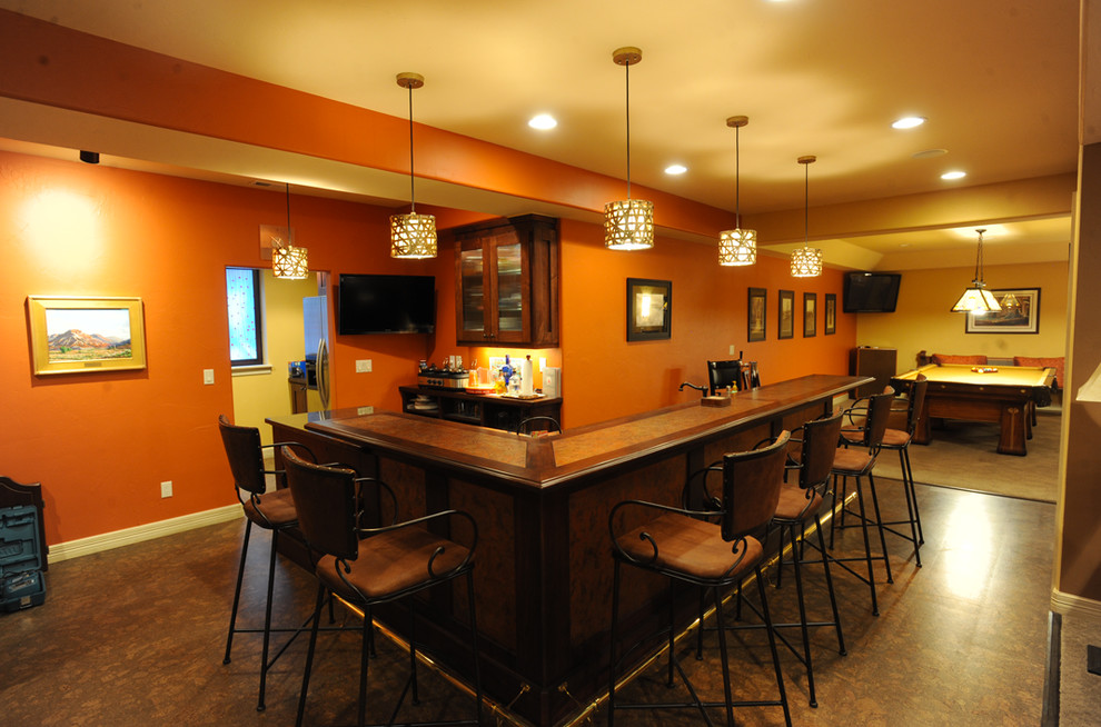 Inspiration for a transitional look-out basement in Denver with cork floors and orange walls.