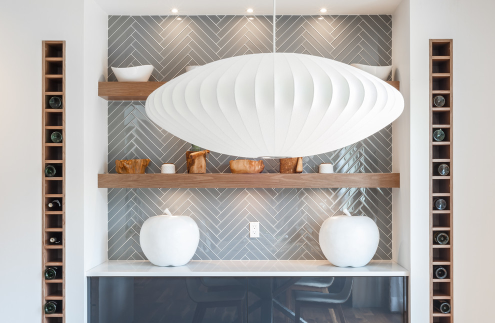 Eat-in kitchen - mid-sized modern eat-in kitchen idea in Calgary with flat-panel cabinets, gray cabinets, quartzite countertops, gray backsplash and glass tile backsplash