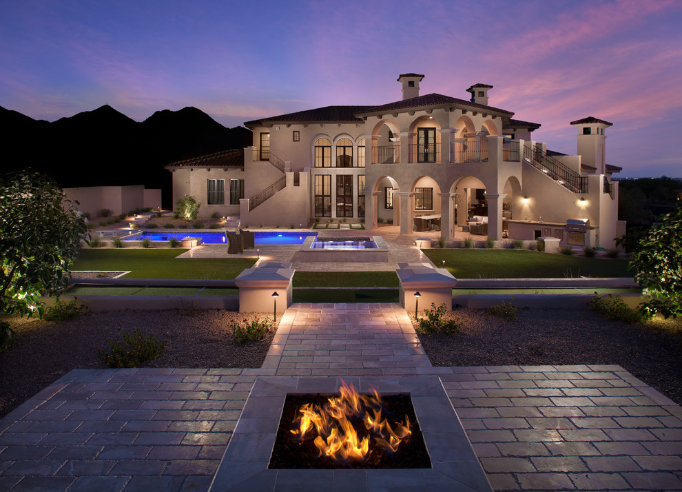Inspiration for a contemporary backyard pool in Phoenix with natural stone pavers.
